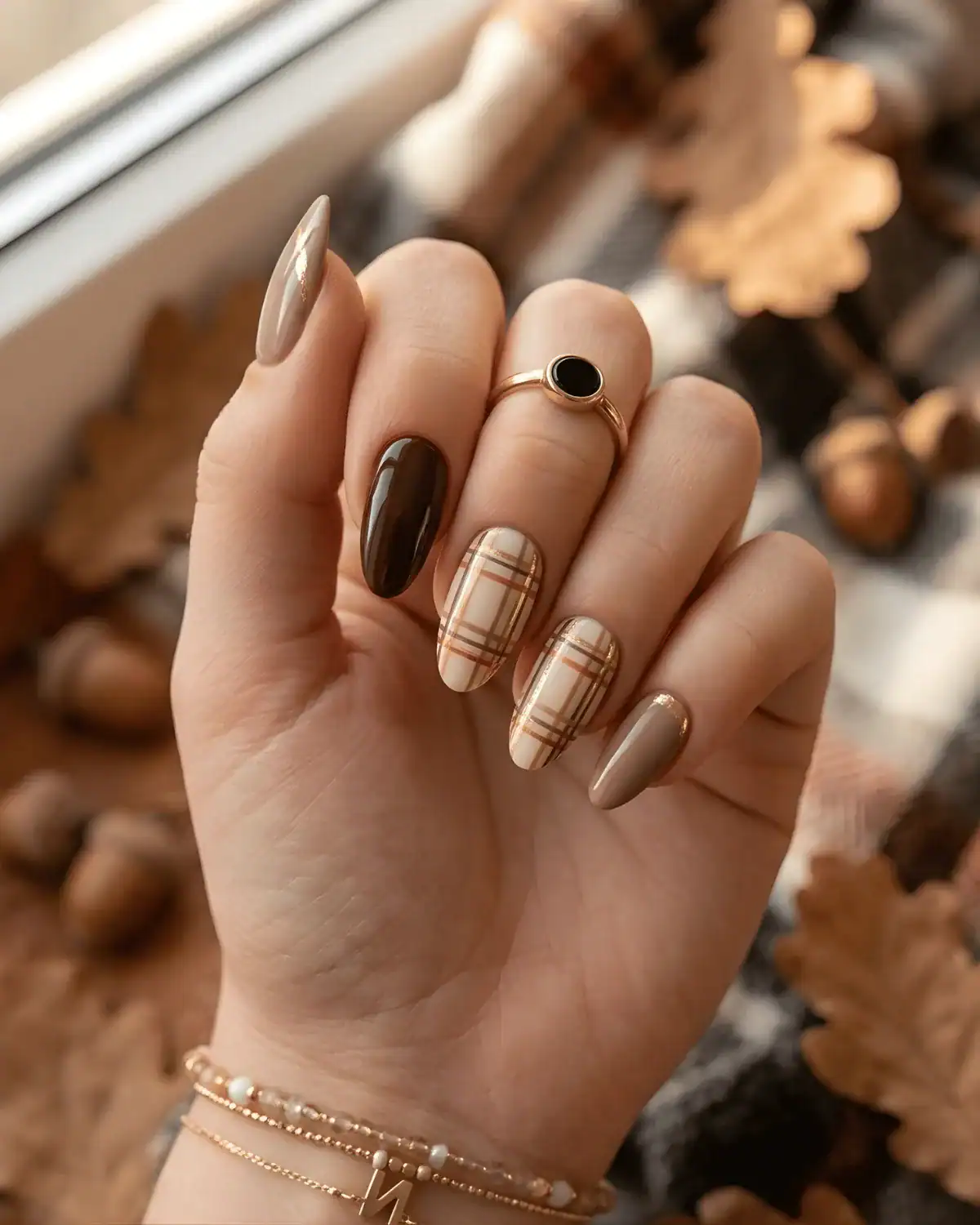 Glossy chocolate brown nails paired with beige and brown plaid nail art
